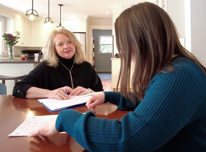 A real estate Agent goes over a buyer broker agreement with a customer