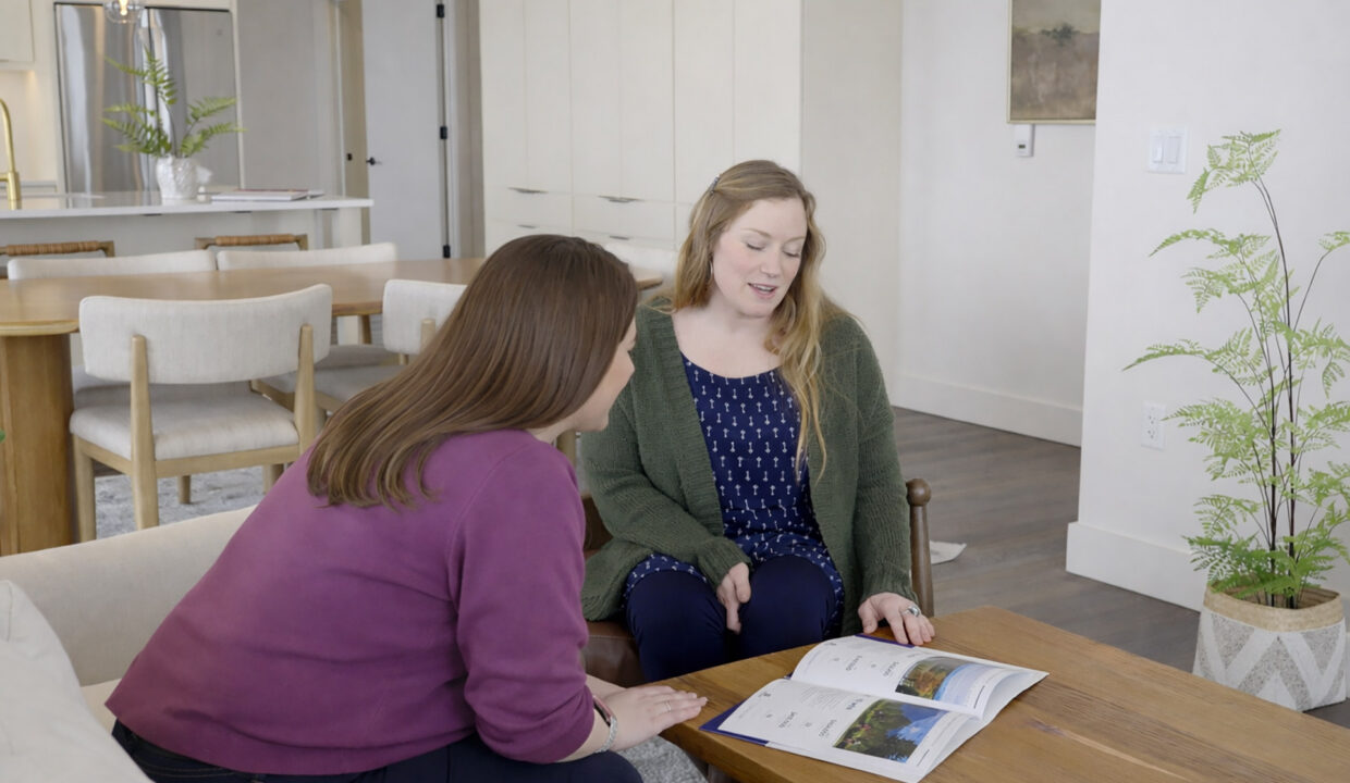 An Agentreviewing-documents with a first-time home buyer