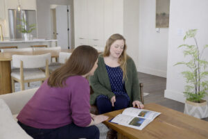 An Agentreviewing-documents with a first-time home buyer