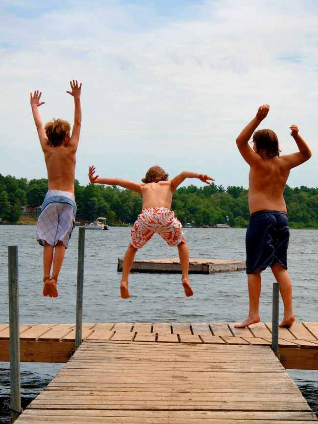 Kids jump into the lake on a Vermont Summer day